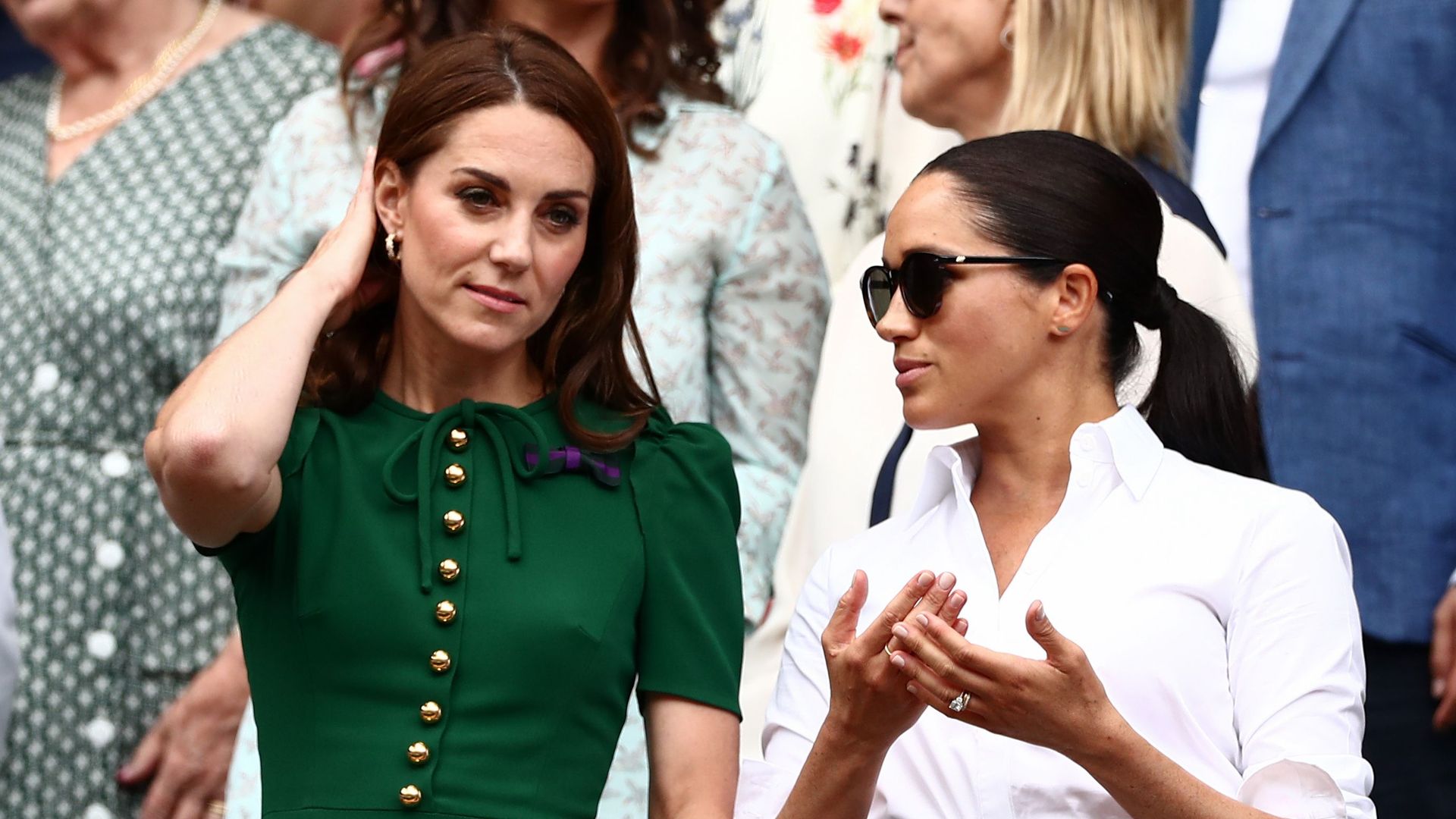 Kate Middleton and Meghan Markle talking in the Royal Box