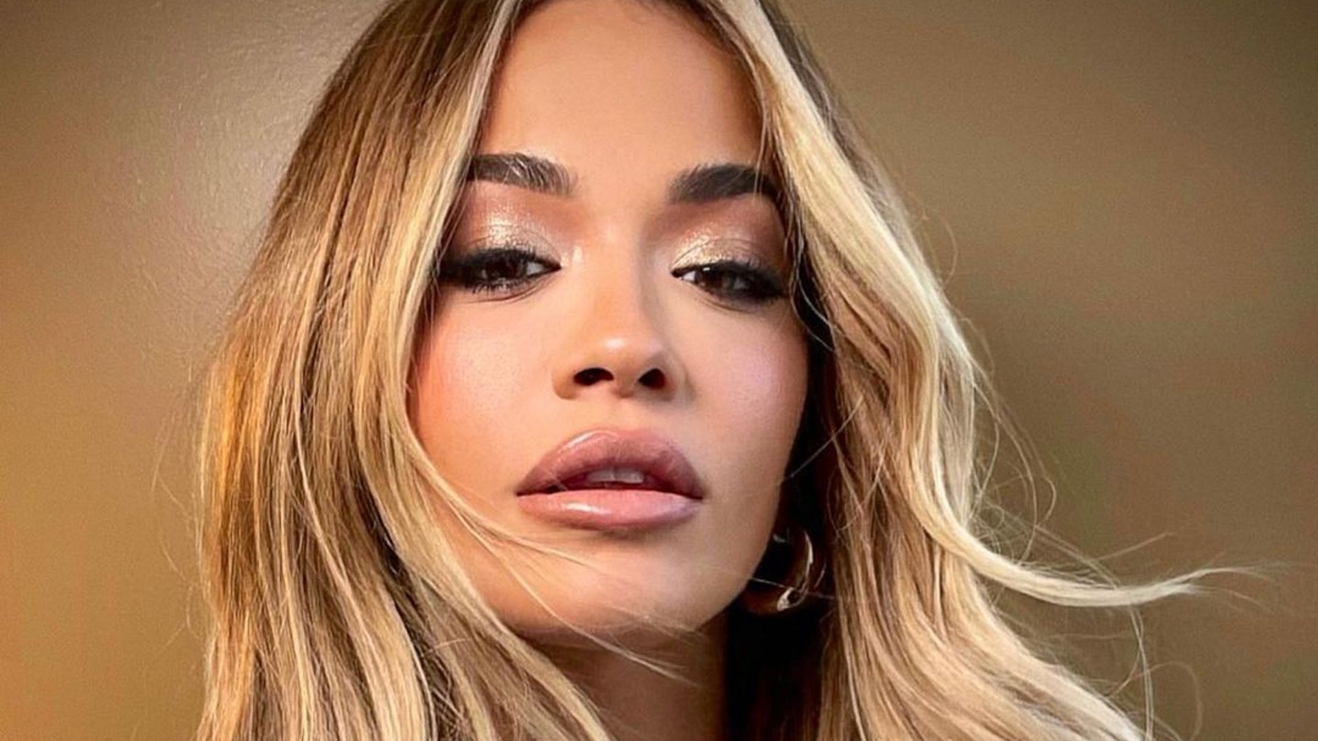 Rita Ora is a golden goddess in shimmery leather bodycon dress