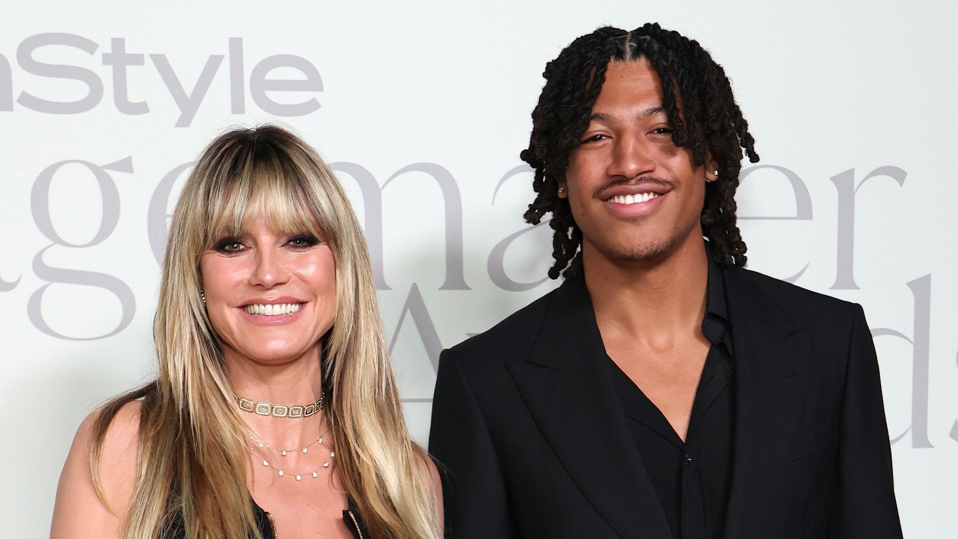 Heidi Klum in black dress and Henry Samuel in black suit attend the InStyle Imagemaker Awards 2025