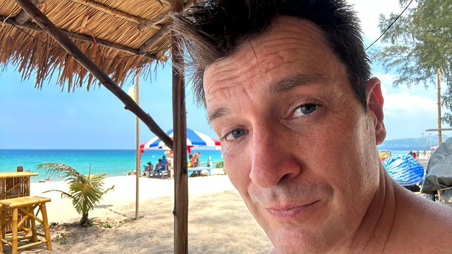 Nathan Fillion celebrating his 52nd birthday on a beach in Thailand