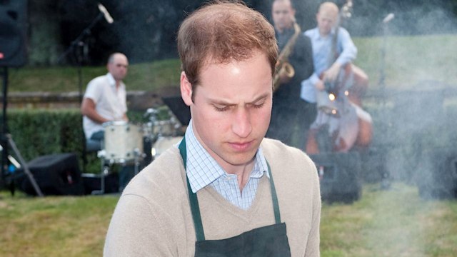 Prince William prepares meat and enjoys a drink at a barbecue at Premiere House on the second day of his visit to New Zealand on January 18, 2010 in Wellington, New Zealand. 