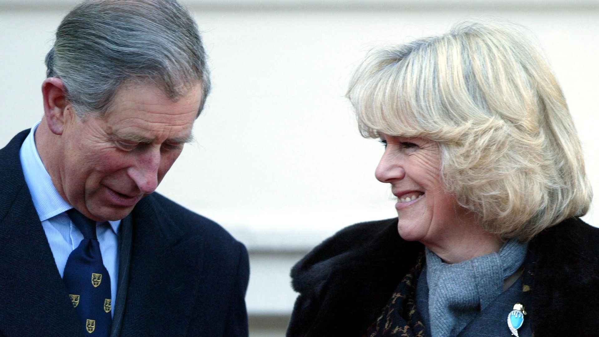 Charles and Camilla laughing and smiling outside Clarence House