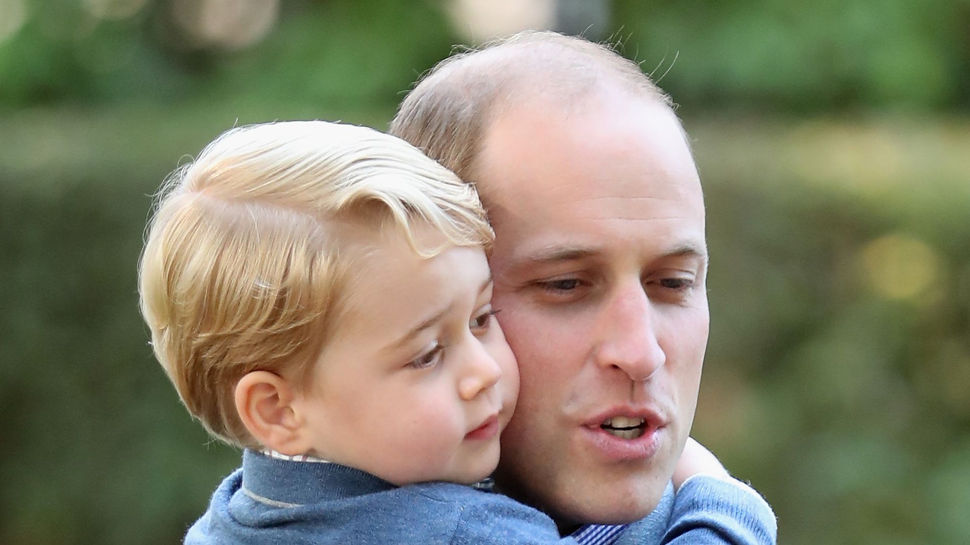 The Prince of Wales hugging Prince George
