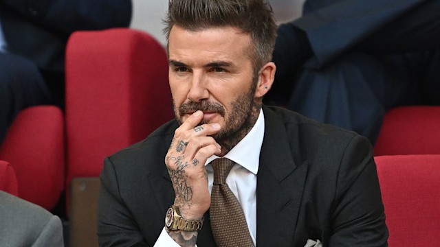 David Beckham intensely watching a football game