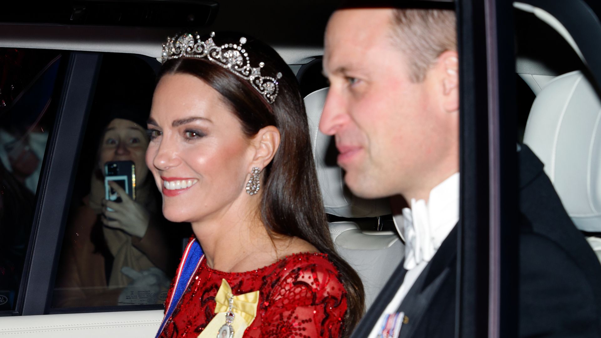 Kate Middleton wearing a tiara in a car with Prince William