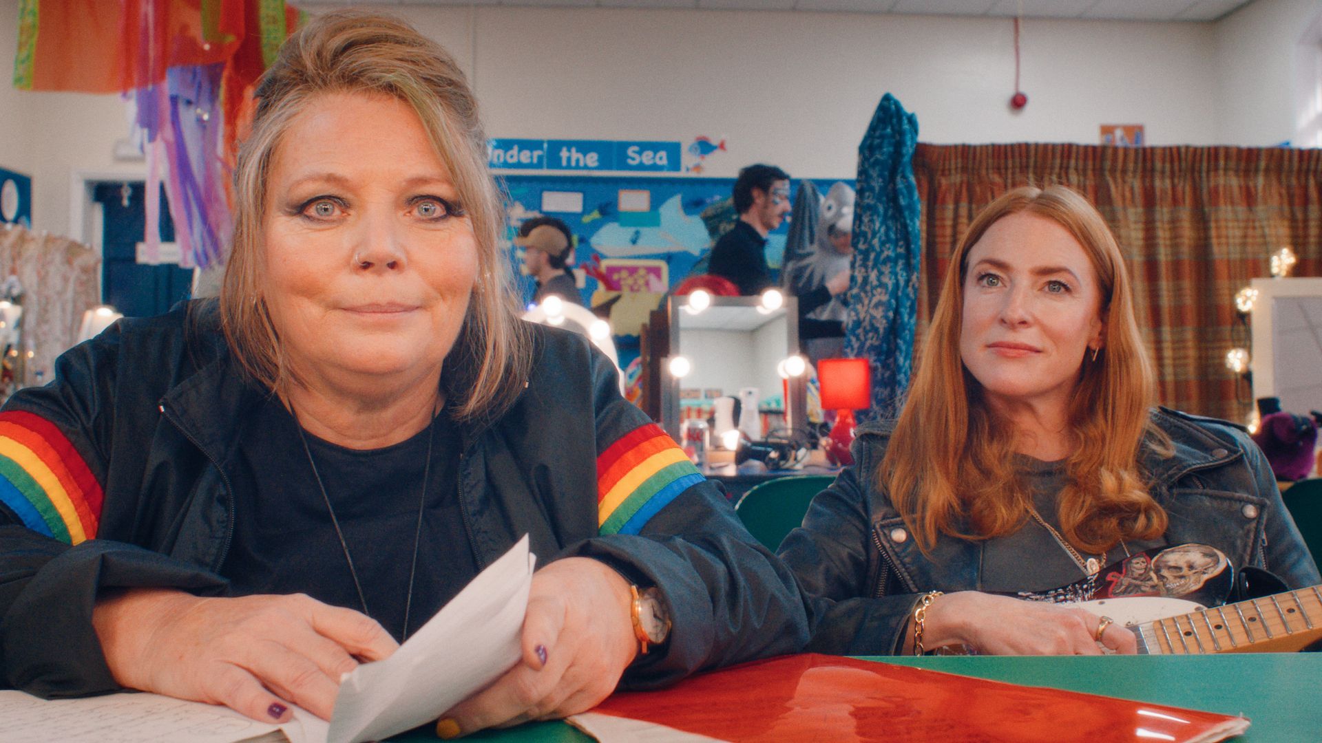 two women sitting at table