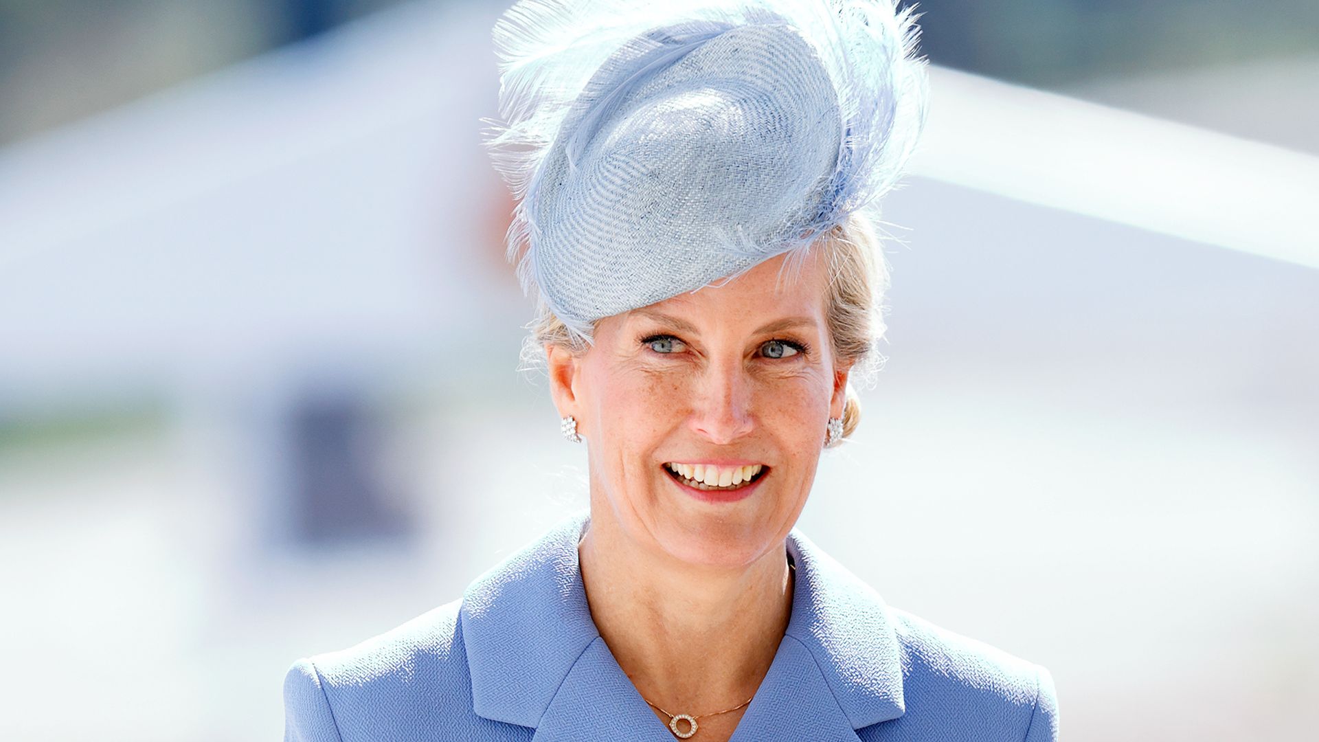 Sophie, Duchess of Edinburgh walking in cornflower blue hat and coat