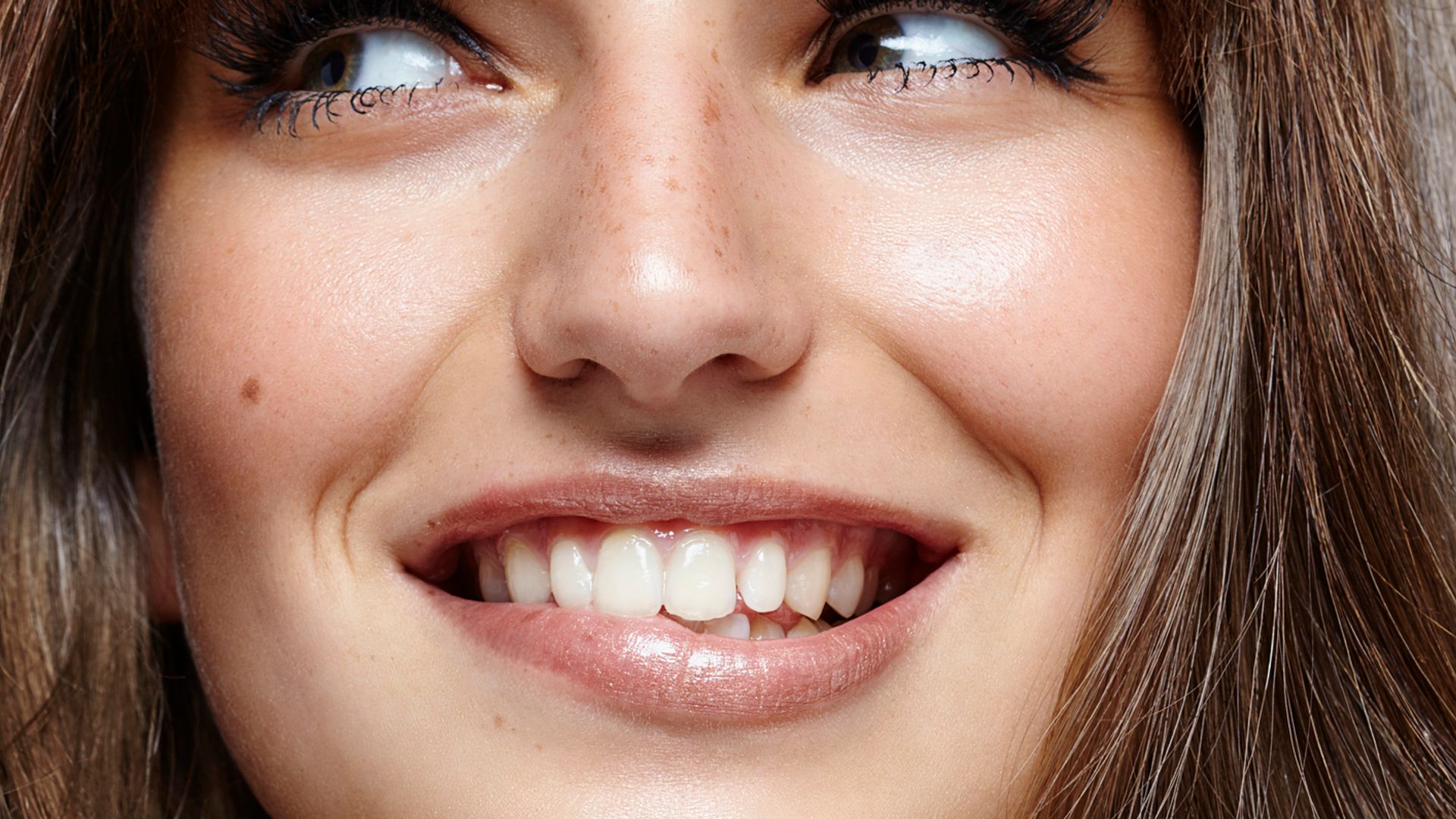 Closeup smiling young woman with fringe and nice teeth