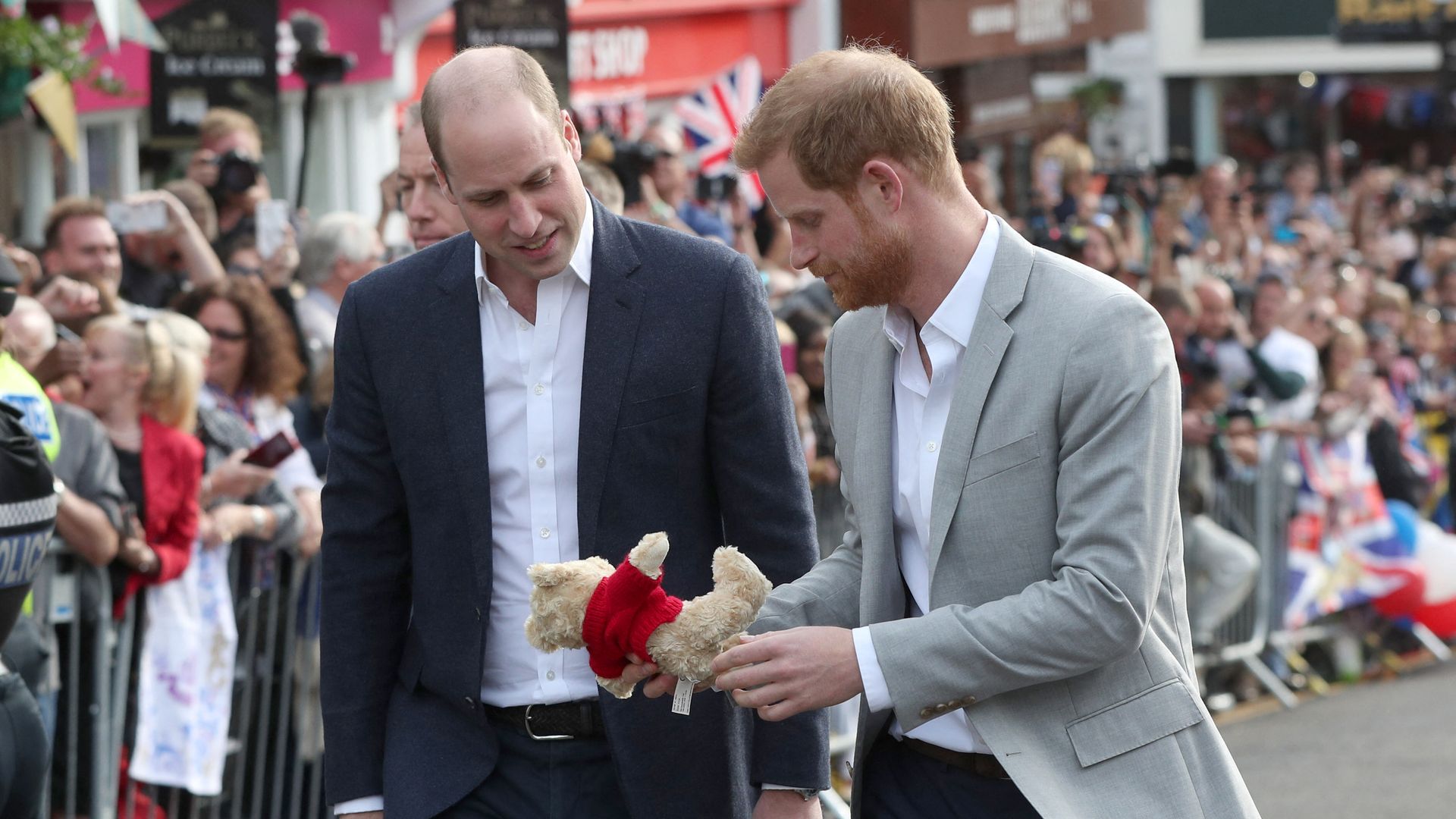 Prince William and Prince Harry looking at a teddy bear