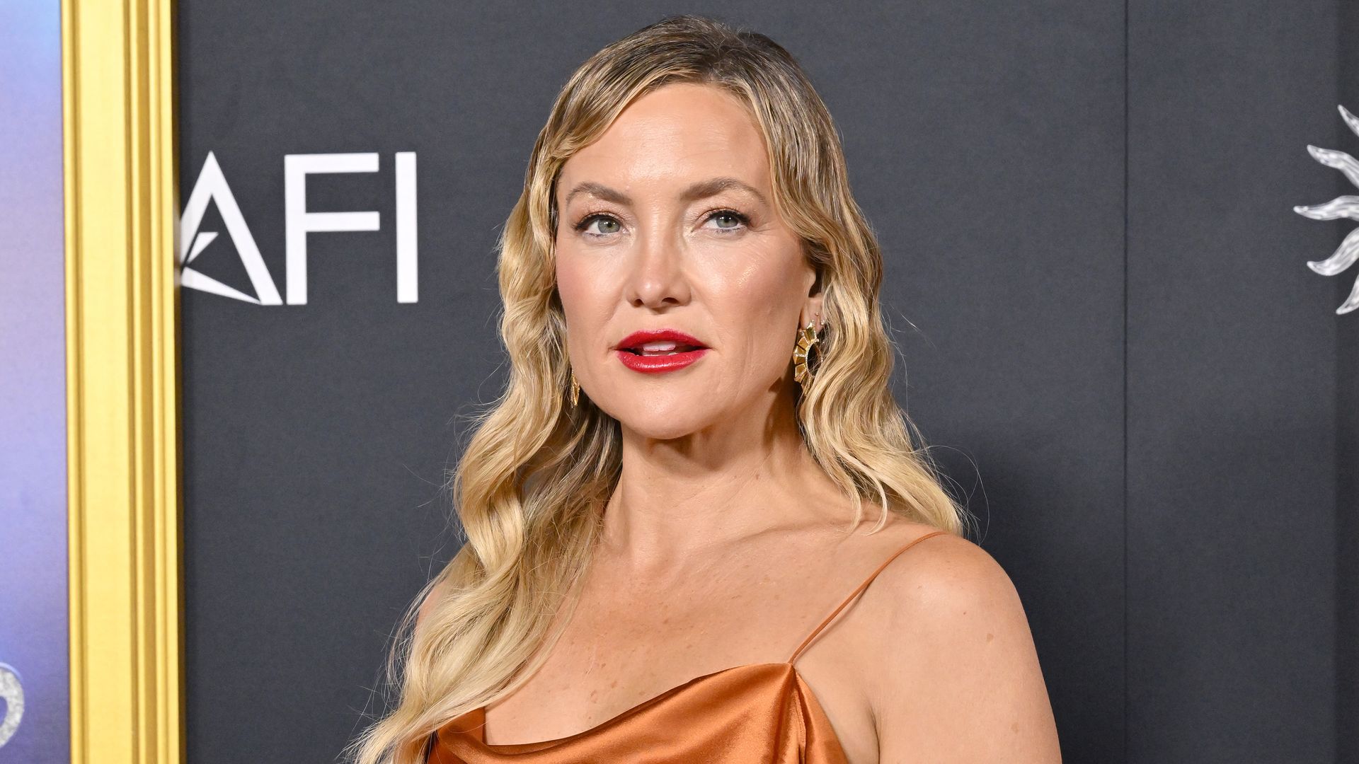 Kate Hudson in orange dress at the 2025 AFI Fest - Closing Night Gala Premiere of "Song Sung Blue" 