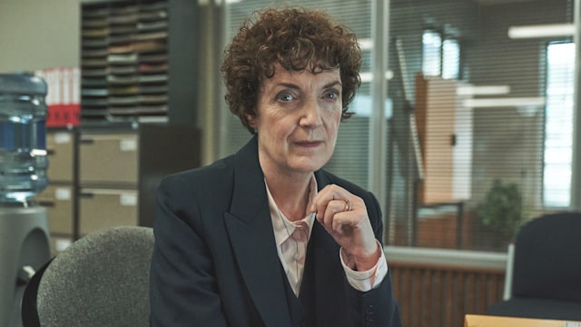 Woman with brunette hair sitting at desk