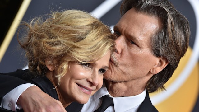 Kevin Bacon kissing Kyra Sedgwick on the forehead on a red carpet