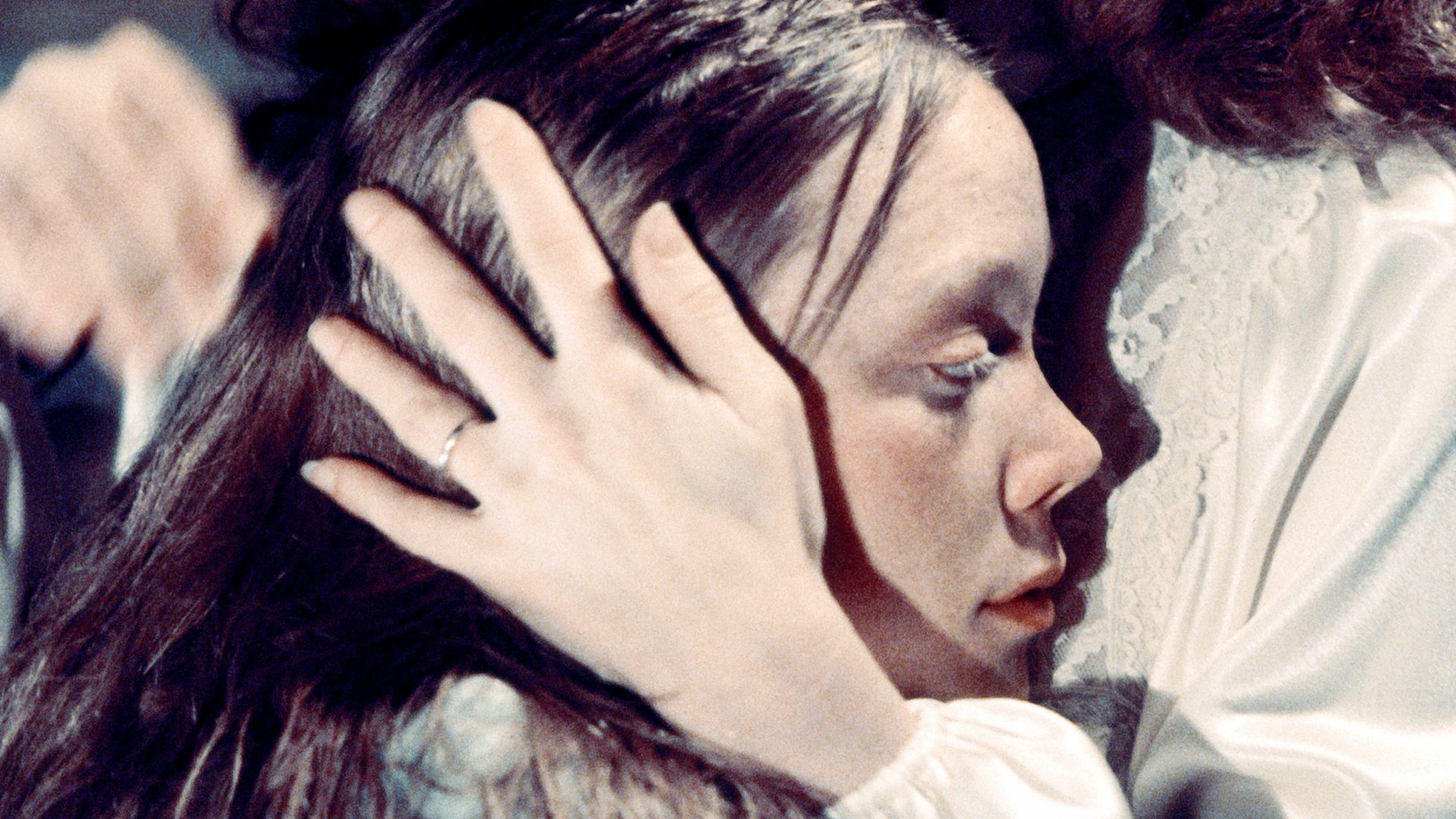 Margaret White, played by Piper Laurie, comforts her daughter Carrie, played by Sissy Spacek, in Brian De Palma's horror film 'Carrie', 1976.