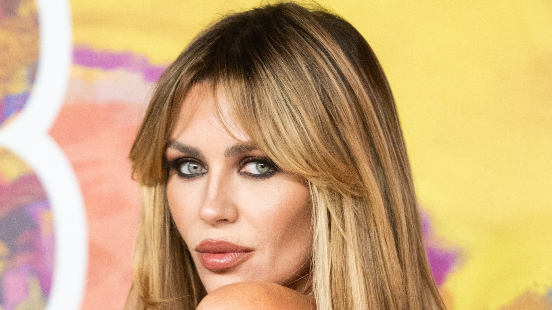 Abbey Clancy resembles a bronzed Bond girl in new beach photos