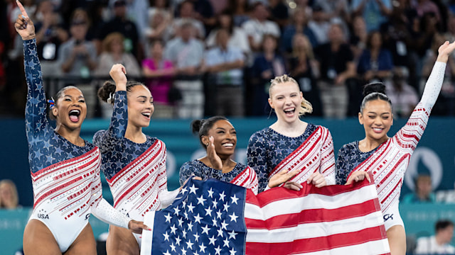 Jordan Chiles, Hezly Rivera, Simone Biles, Jade Carey, Sunisa Lee of USA celebrate victory while the womenÂ´s team final with the USA flag  on day four of the Olympic Games Paris 2024 at Bercy Arena on July 30, 2024 in Paris, France