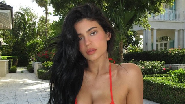 Kylie Jenner poses on a sun-lounger in a red studded bikini