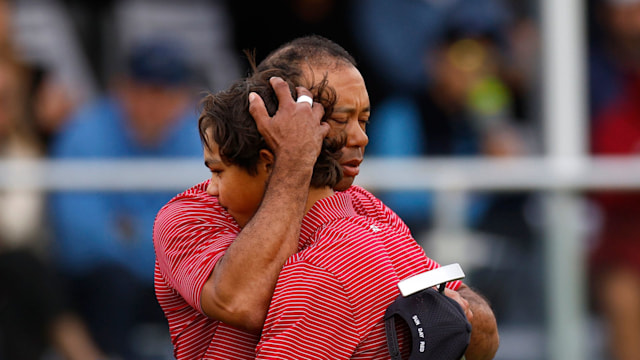 tiger woods hugging son charlie on golf course