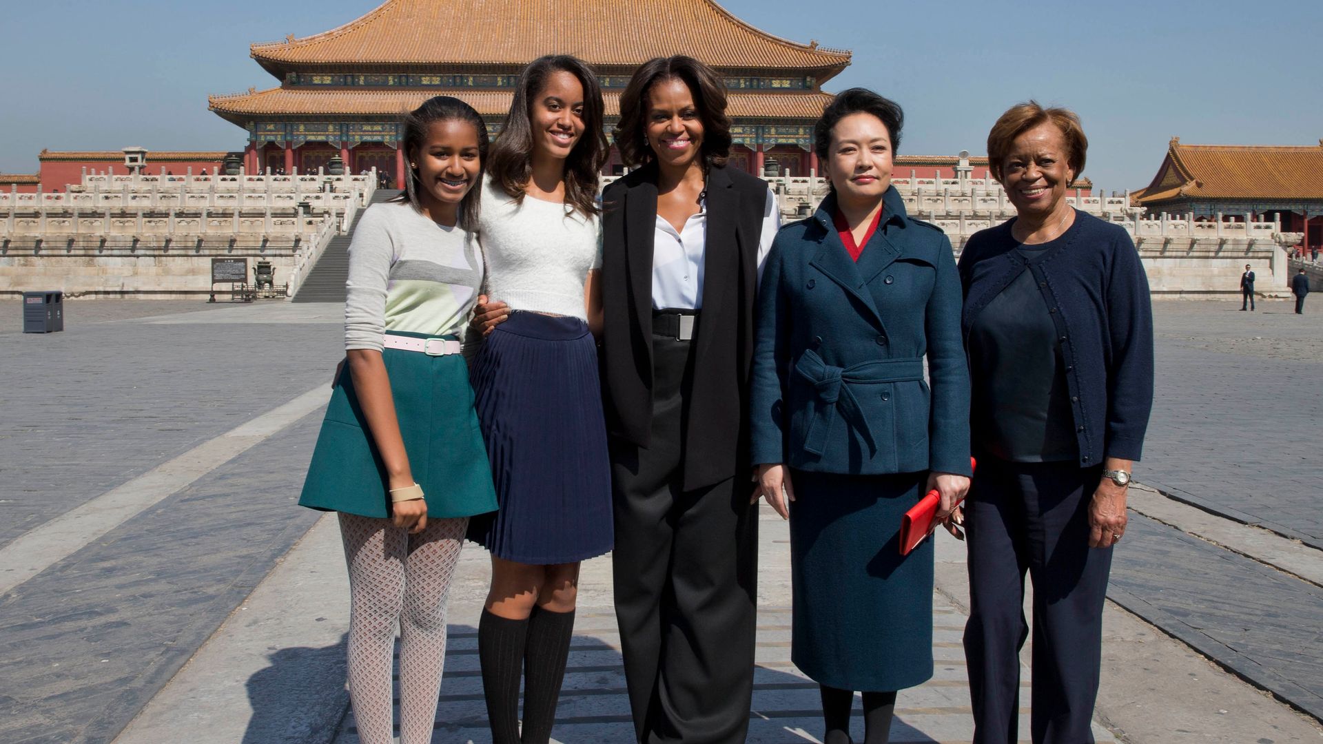 U.S. first lady Michelle Obama, center, her daughters from left Sasha, Malia, Michelle Obama's mother Marian Robinson, right, and Peng Liyuan, wife of Chinese President Xi Jinping pose for photograph as they visit to Forbidden City, March 21, 2014 in Beijing, China. Michelle Obama's one-week-long visit in China will be focused on educational and cultural exchanges.