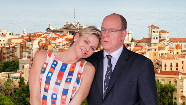 Princess Charlene and Prince Albert against Monaco palace