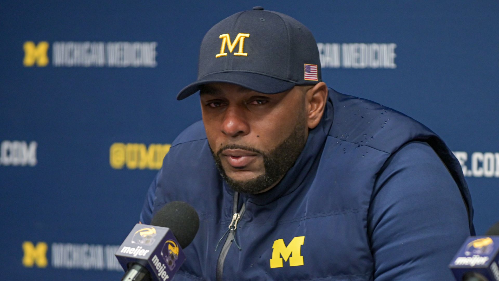 Head Football Coach Sherrone Moore of the Michigan Wolverines speaks to media during the post game press conference after a college football game against the Ohio State Buckeyes at Michigan Stadium on November 29, 2025 in Ann Arbor, Michigan.