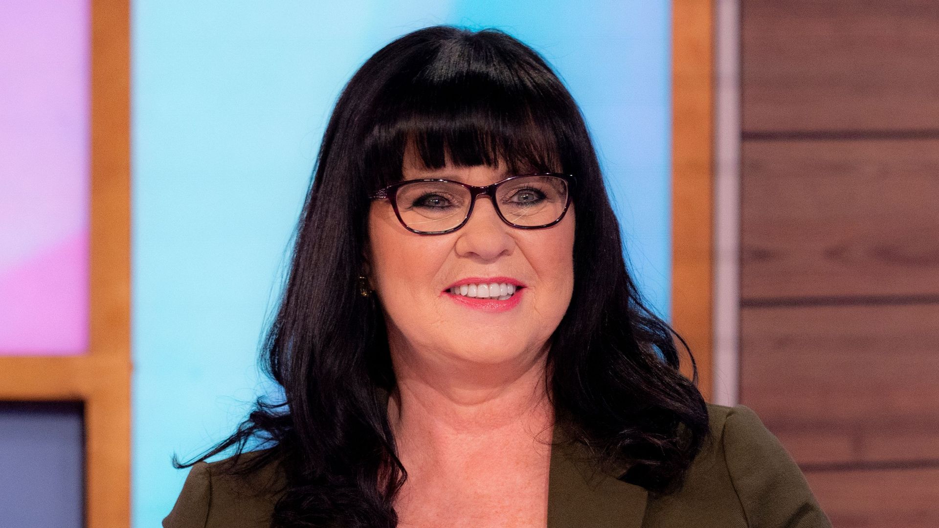 Coleen Nolan in brown jacket and glasses