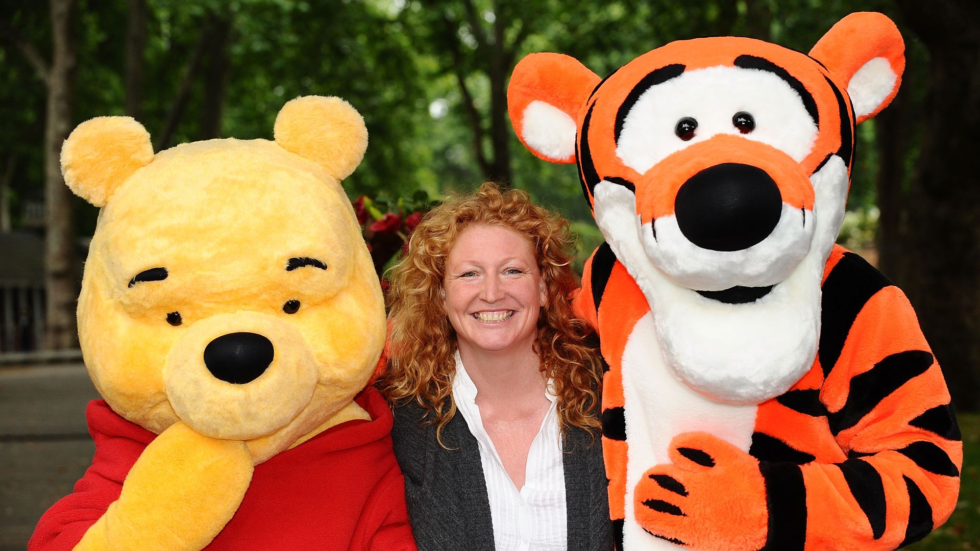 Charlie Dimmock in a garden with Winnie the Pooh and Tigger