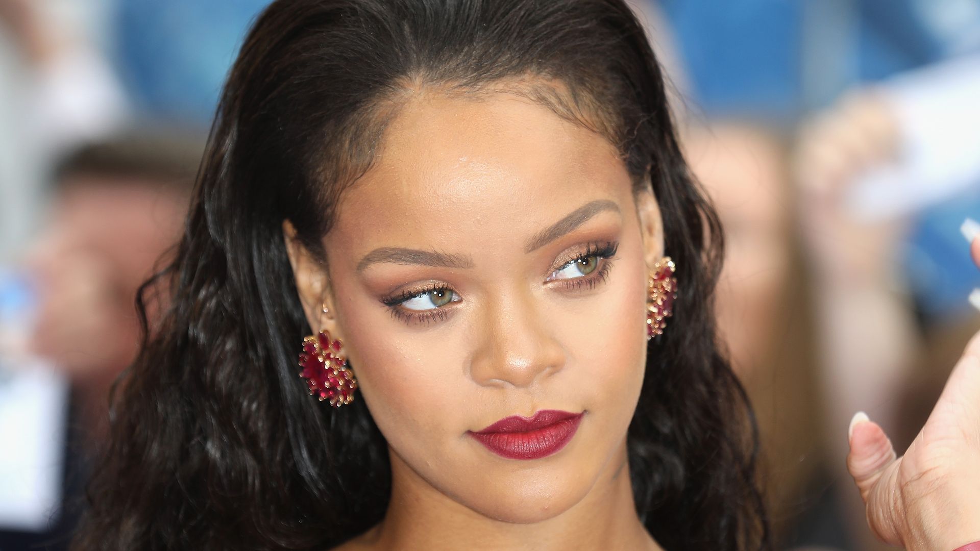 Rihanna causes a stir as she poses in red hot lace lingerie