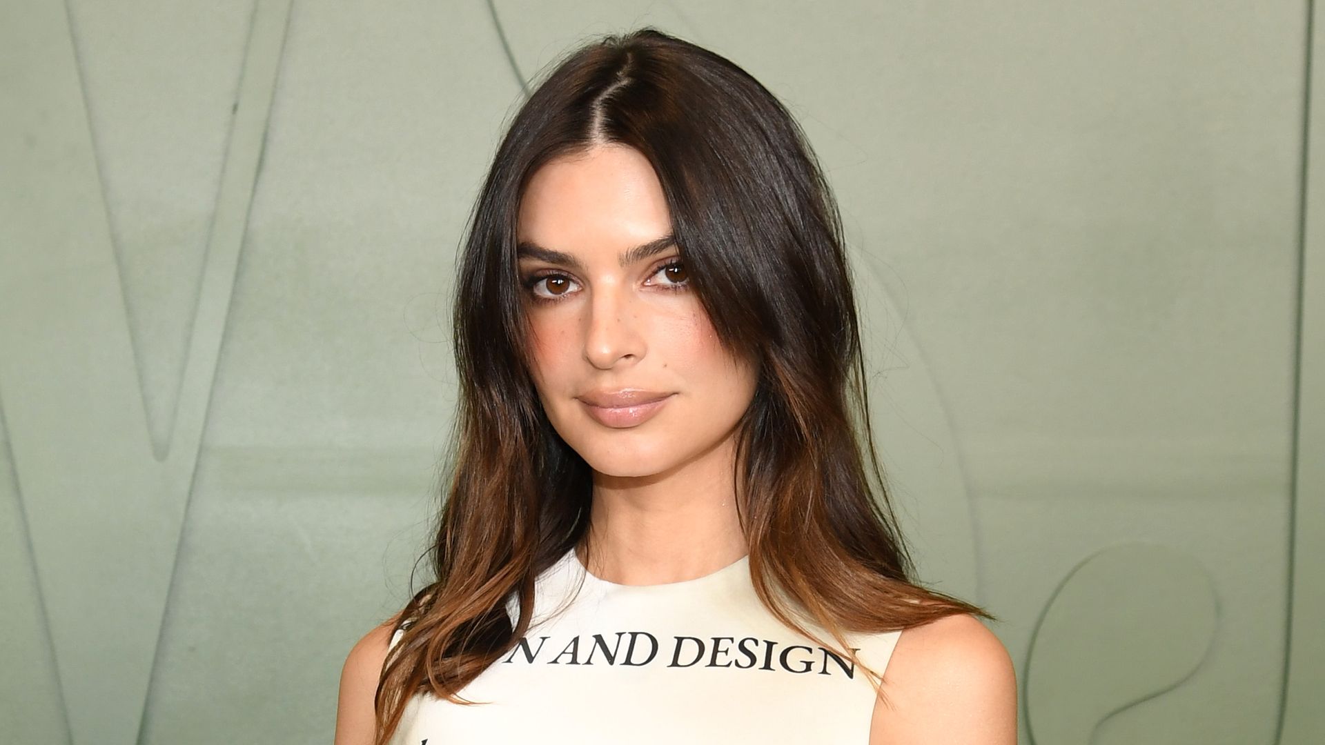 Emily Ratajkowski styles her favourite trainers with a plunging neck mini dress