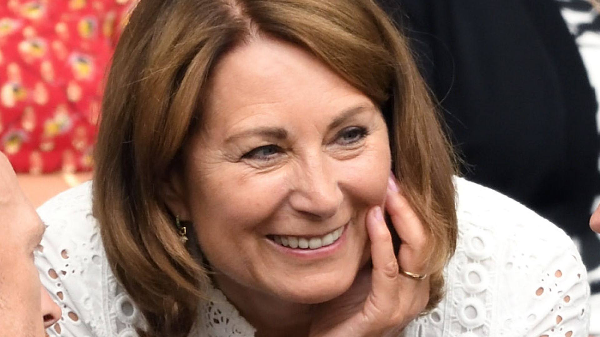 Carole Middleton in a white lace dress with her head on her hand