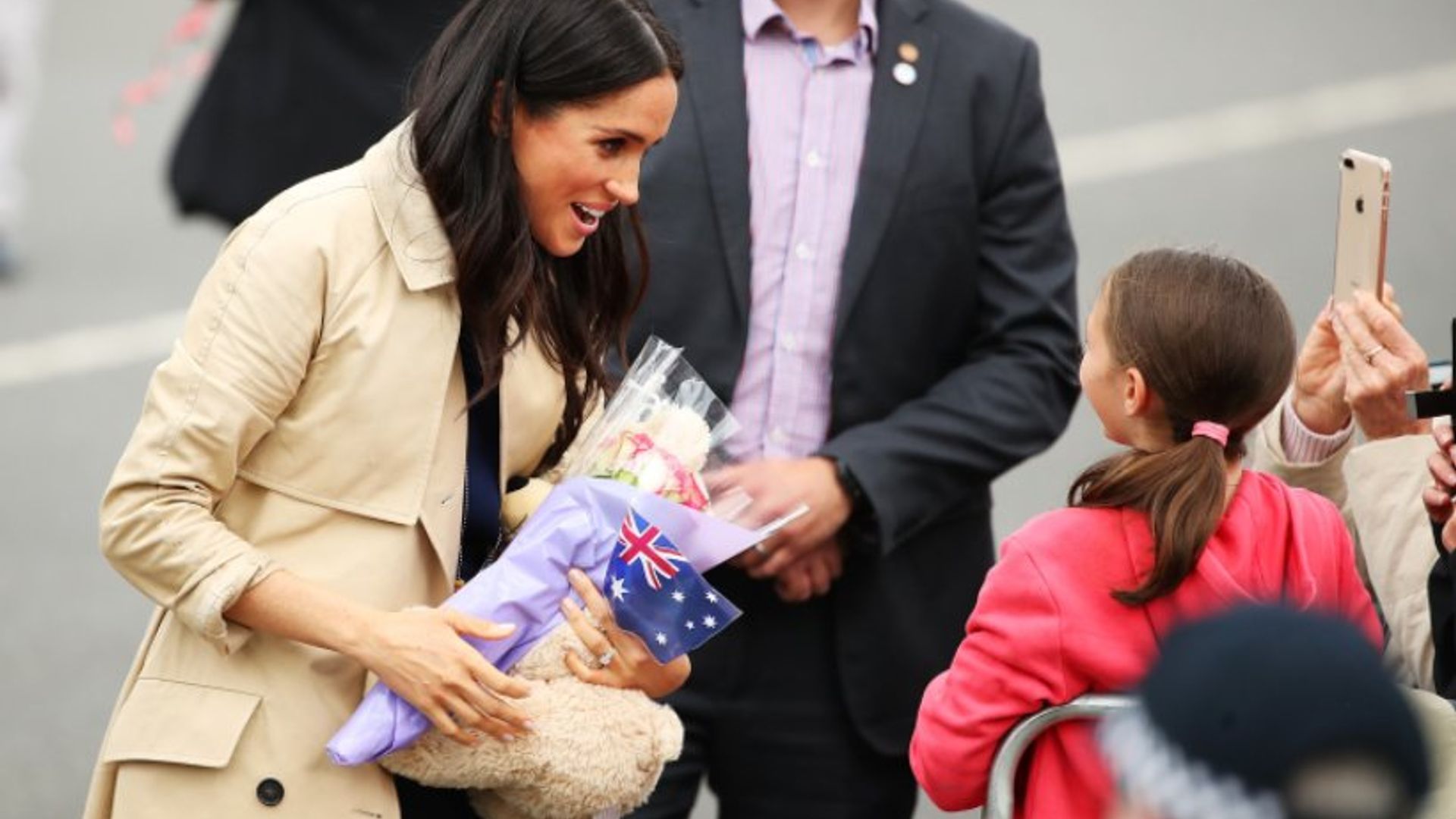 Meghan Markle looks chic in a navy dress for a visit to Melbourne (and we love her Gucci bag!)
