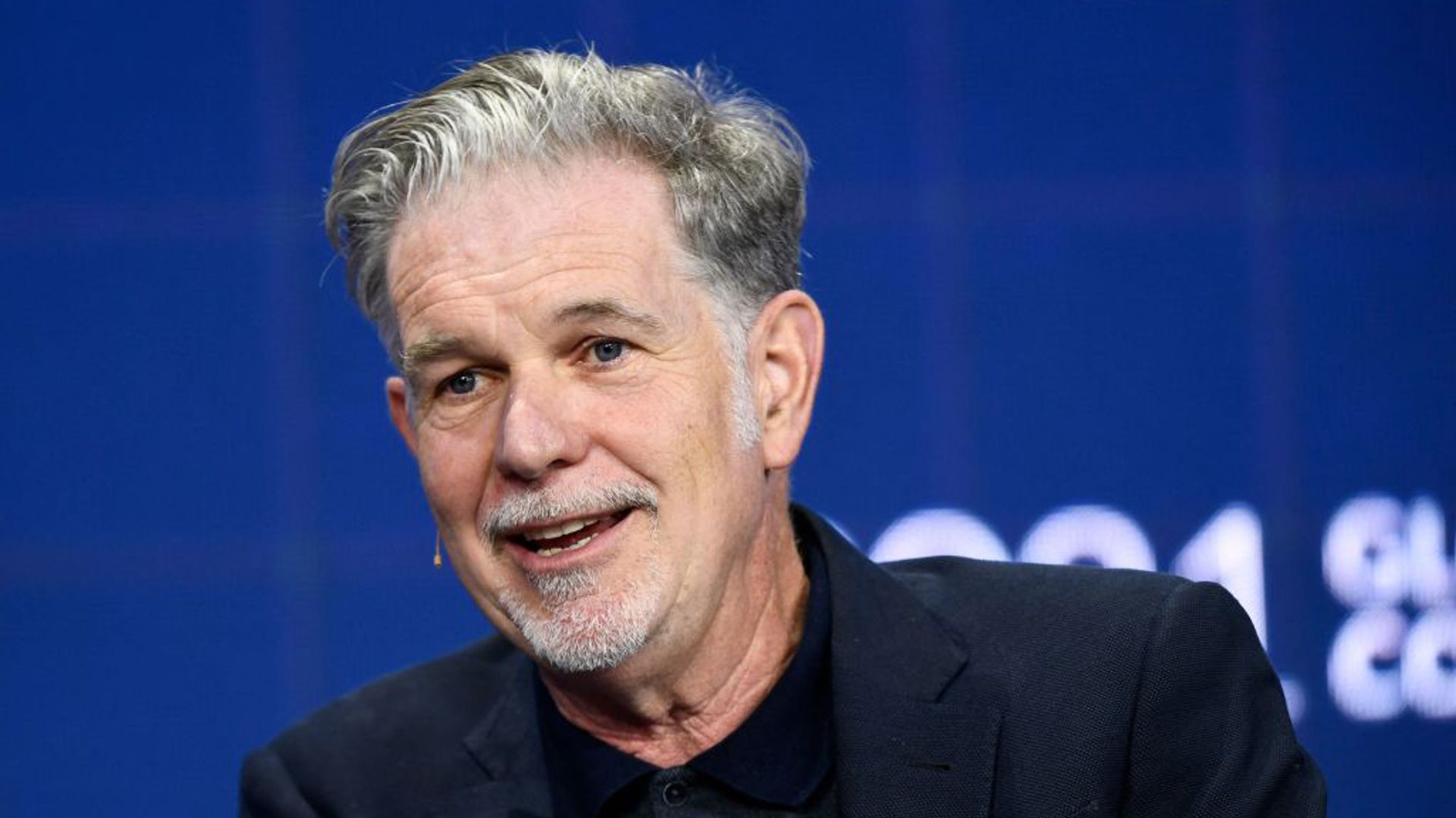 Reed Hastings wearing a navy suit 