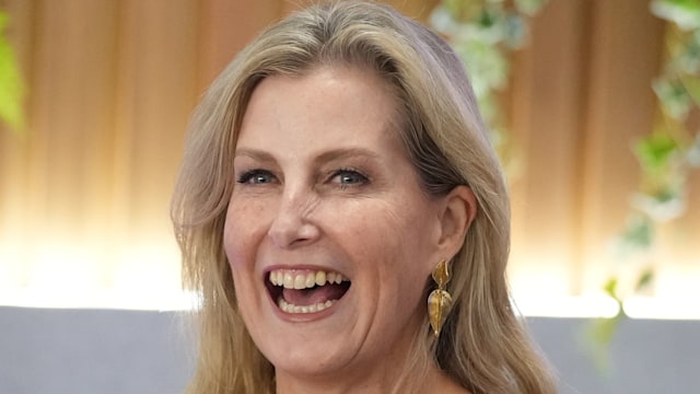 woman smiling in black and white dress