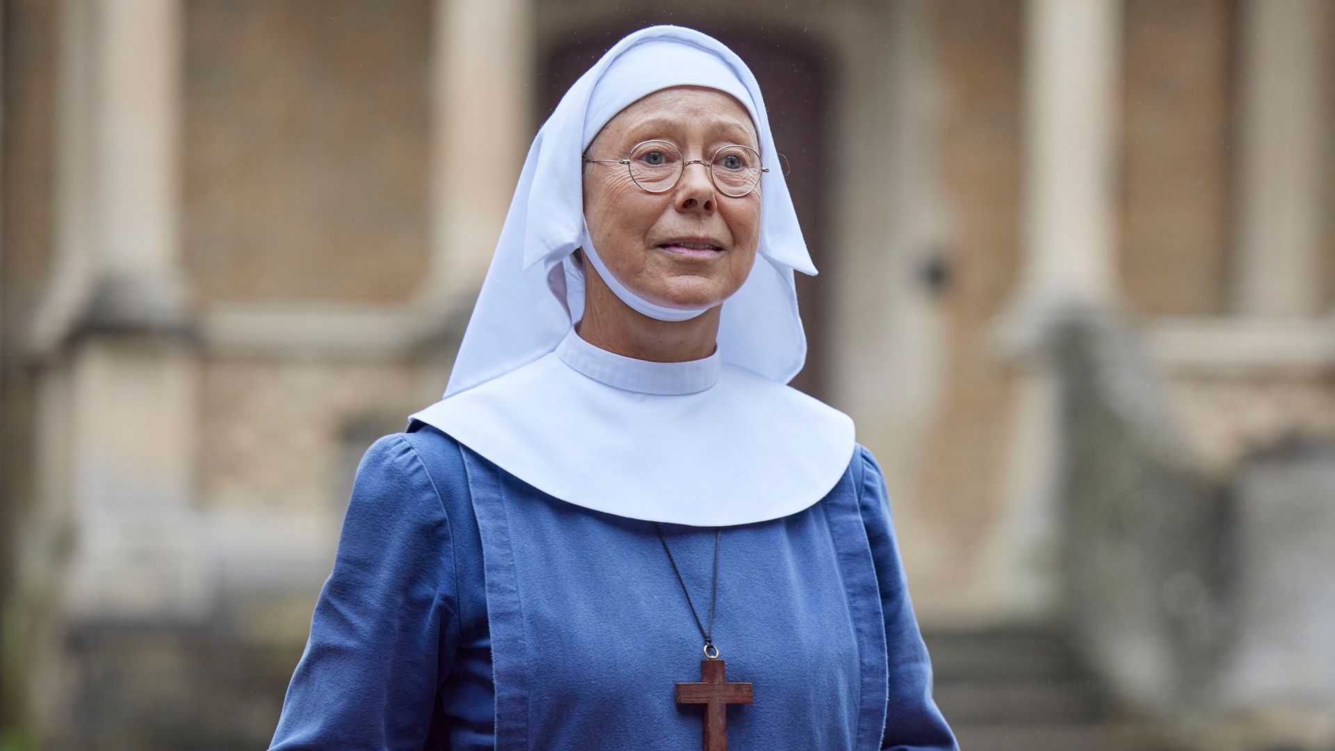 Woman wearing nun's habit standing in street