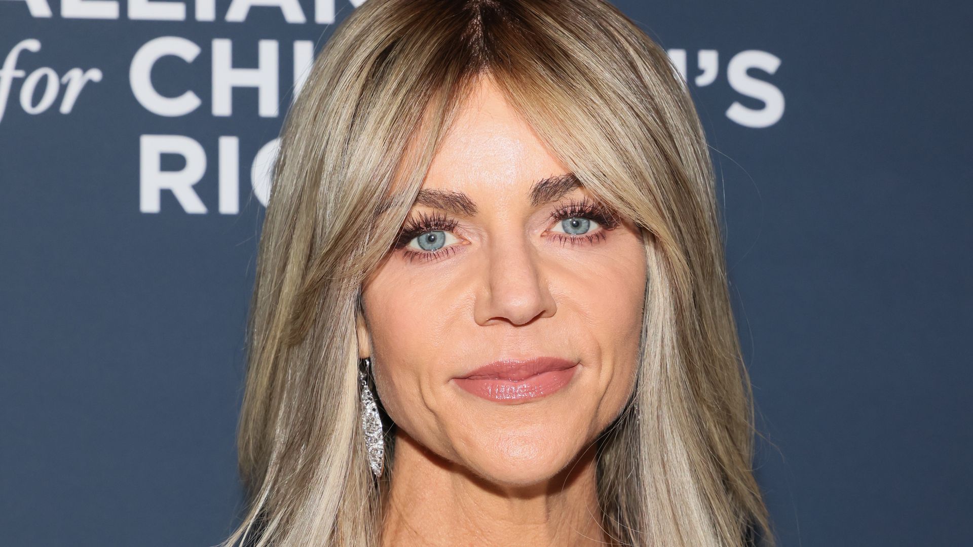 Kaitlin Olson looks glam long hair, somber expression