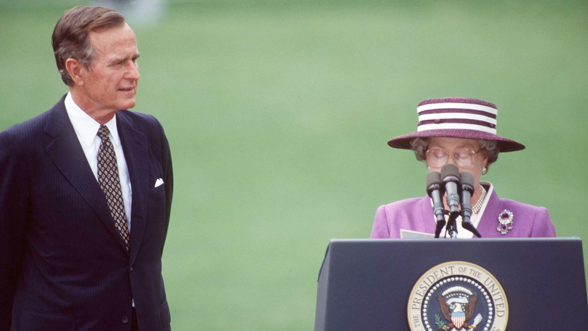 queen giving speech next to President Bush 