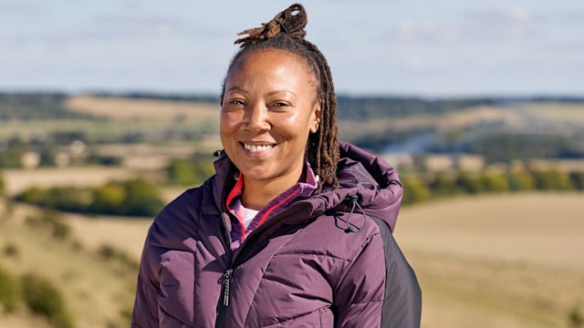 Woman smiling in a purple puffer coat