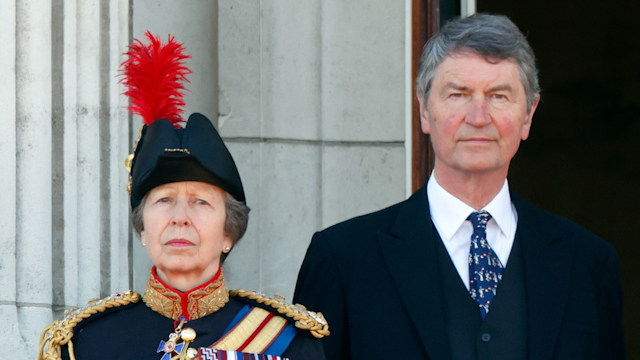 Princess Anne and Sir Timothy Laurence stand on the balcony of Buckingham Palace