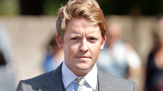 Hugh Grosvenor, Prince George's godfather, in a grey three-piece suit in the sunshine