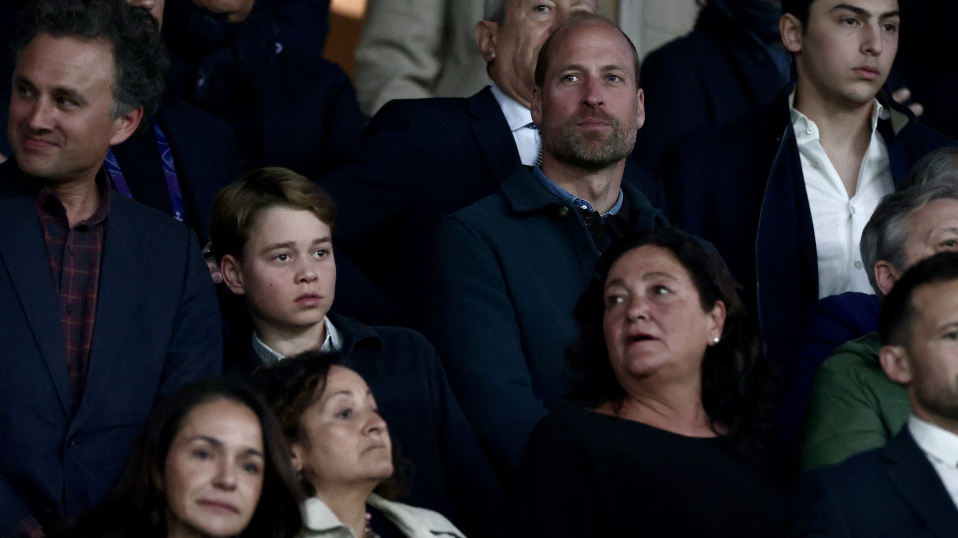 Britain's Prince William, Prince of Wales (CR) and his son Britain's Prince George of Wales (CL) look on from the stands ahead of the UEFA Champions League Quarter final first leg football match between Paris Saint-Germain (FRA) and Aston Villa (ENG) at the Parc des Princes stadium in Paris on April 9, 2025