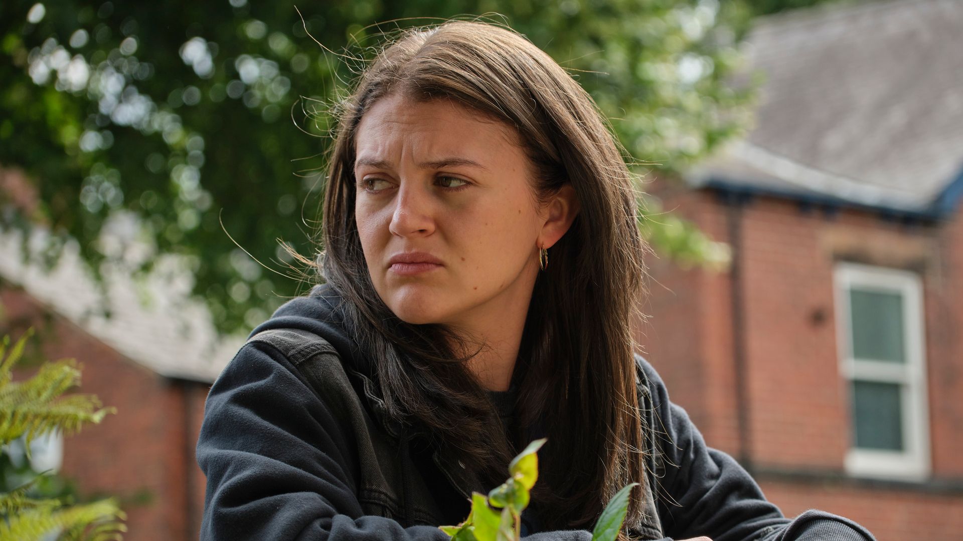 brunette young woman standing in street