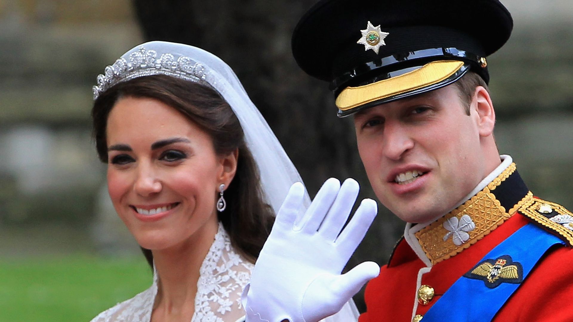Prince William and Kate Middleton waving to crowds following their royal wedding in 2011
