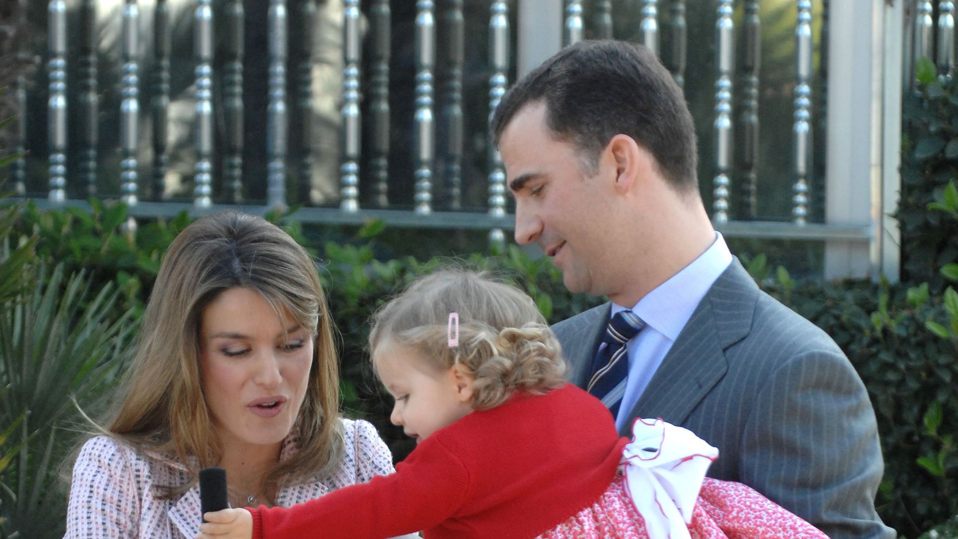 Queen Letizia carrying a baby Infanta Sofia while King Felipe holds a young Princess Leonor