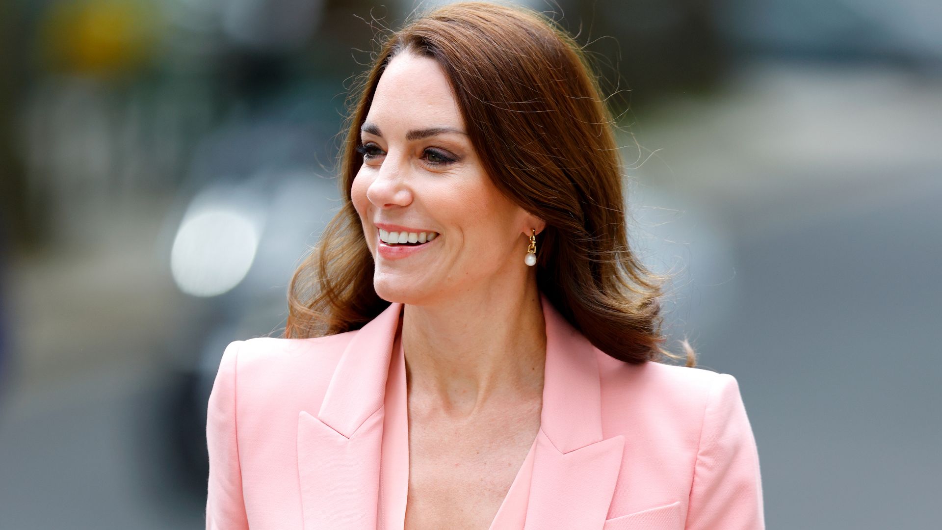 Princess Kate smiling looking stylish in a pink blazer