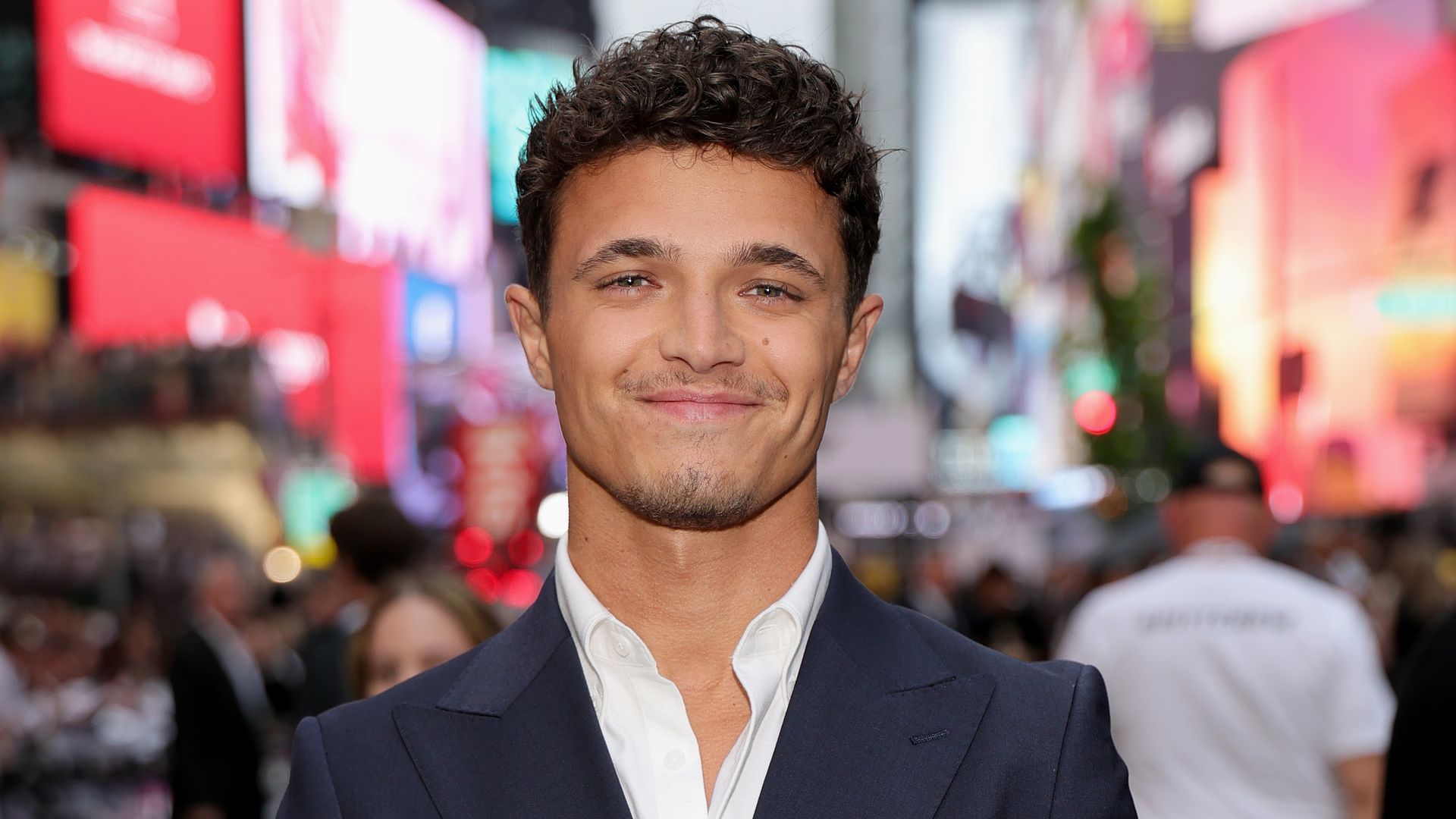 Lando Norris in a suit and white shirt