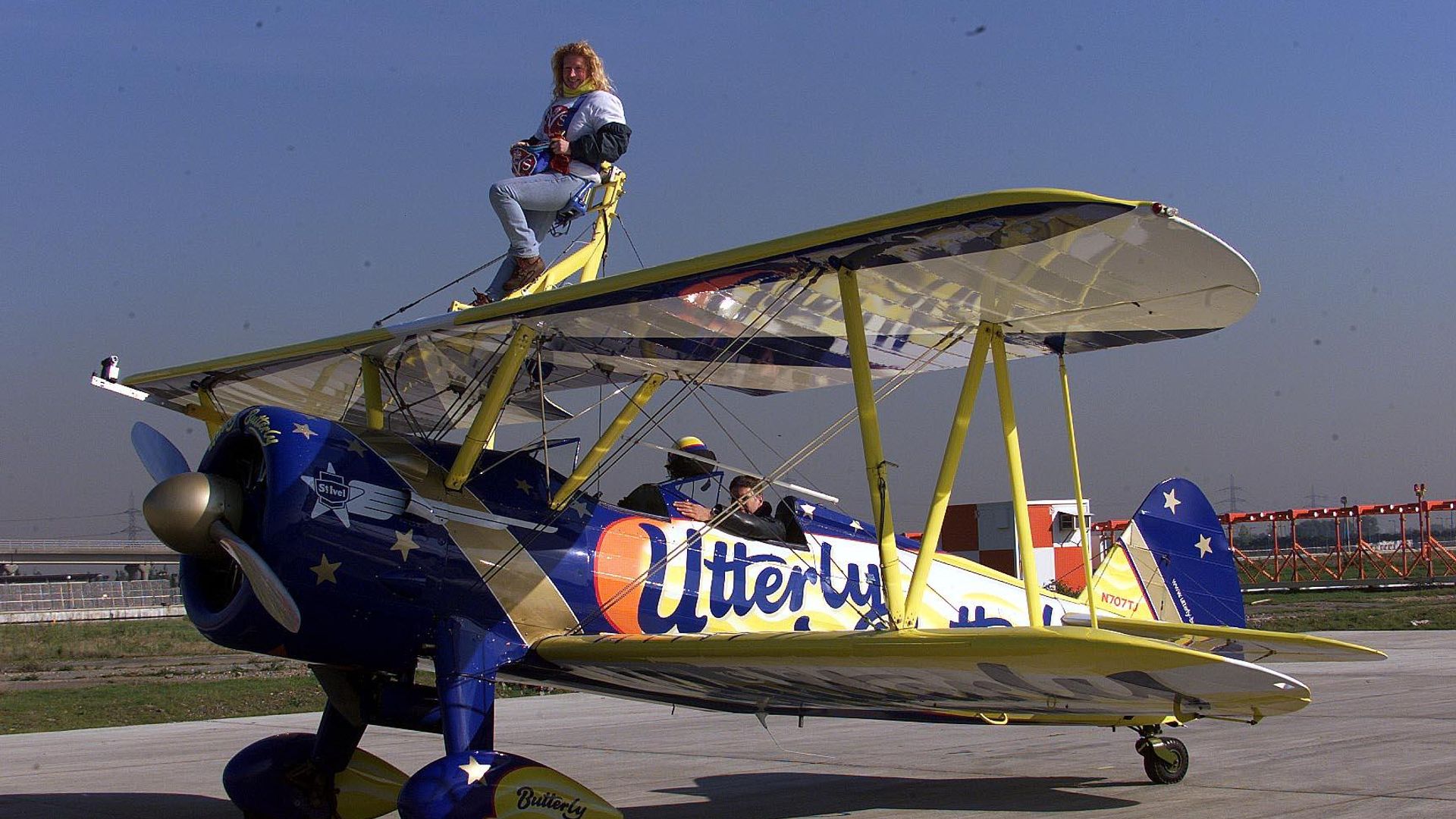 Charlie Dimmock strapped to a bi-plane