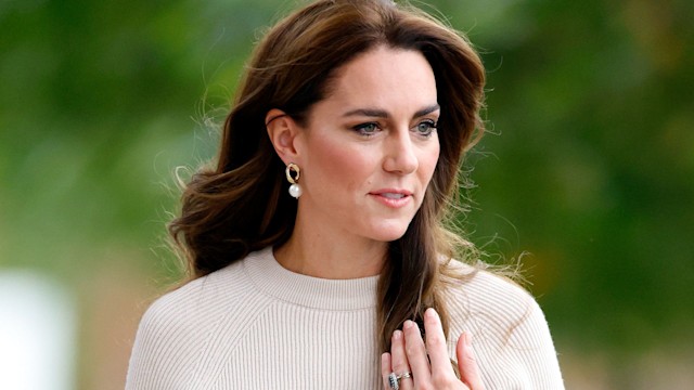 Kate Middleton in a white top wearing her engagement ring