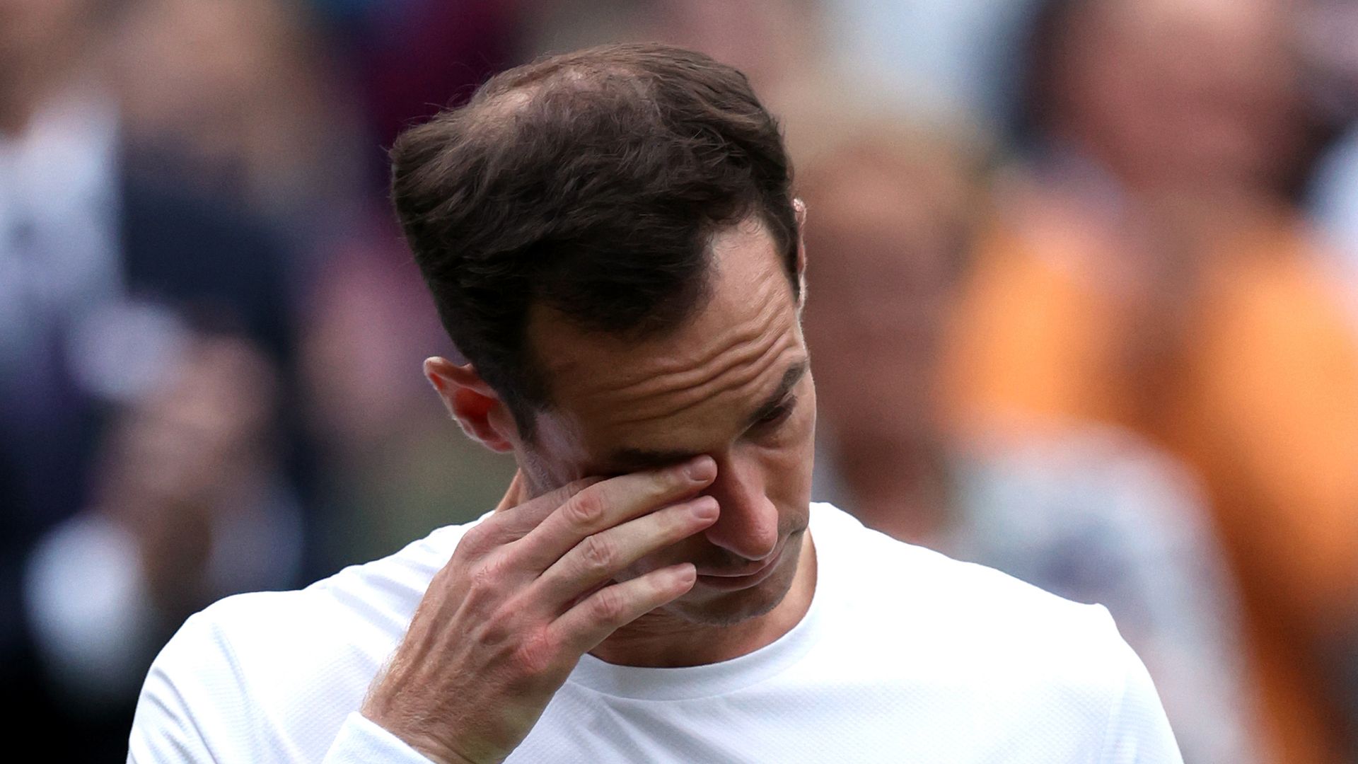 Andy Murray wiping a tear away from his face