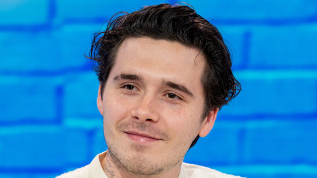 man sitting on sofa in white jumper