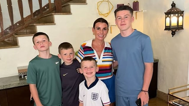 Coleen Rooney and her four sons inside a living room