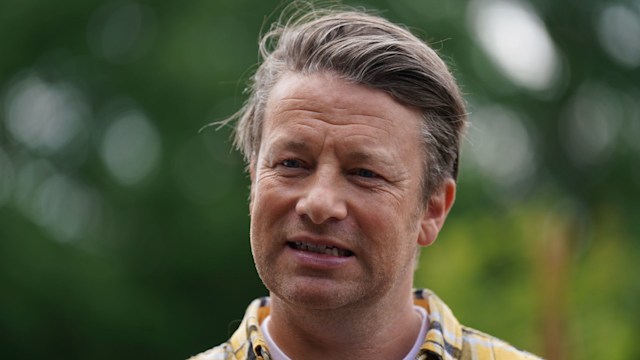 Jamie Oliver grimacing in a yellow check shirt